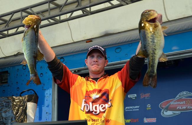 Pro winner Brandon McMillan holds up his two biggest bass from day four on Lake Okeechobee.
