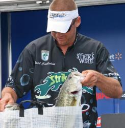 Pro leader Todd Castledine reaches into his weigh bag to show off a couple of Texoma largemouth.