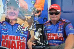 Mark Rose of Marion, Ark., shows off his first-place trophy on Pickwick Lake after winning his first-ever FLW Tour title.