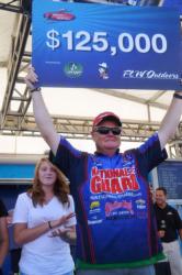 Mark Rose of Marion, Ark., proudly displays his first-place check after winning the FLW Tour event at Pickwick Lake.