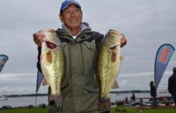 Pro leader Gary Yamamoto holds up his two biggest bass from day one on Lake Champain. 