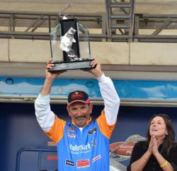 Veteran pro Paul Elias holds up his trophy for winning the FLW Tour event on Lake Guntersville.