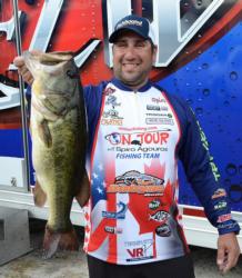 Co-angler leader Spiro Agouros holds up an 8-pound, 1-ounce largemouth, the Snickers Big Bass of the opening day.