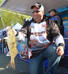 Fourth-place pro Brian Bjorkman holds up a chunky Mississippi River walleye.