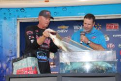 Tournament winner Phil Marks loads a toad into the weigh-in tank.