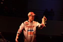 Ed Stachowski holds up a one of the five fish he brought to the stage. 