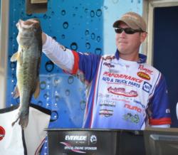 Fifth-place pro Brandon McMillan holds up a 6-pound, 7-ounce largemouth, the largest bass from day one on Smith Lake. 