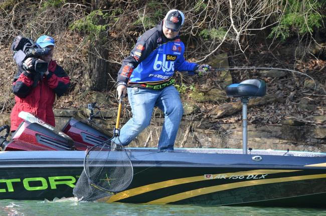 Ray Scheide reaches to net a Smith Lake largemouth.