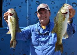 Third-place co-angler Randy Clark holds up his two biggest bass from day two on Lake Eufaula. 