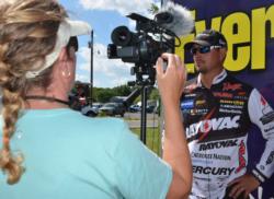 Day-two pro leader Jason Christie conducts an interview during weigh-in at Grand Lake.