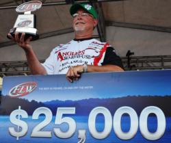 Co-angler Keith Honeycutt of Temple, Texas, shows off his first-place trophy after winning the FLW Tour event on Grand Lake.