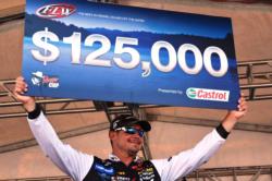 Jason Christie of Park Hill, Okla., proudly displays his first-place check after winning the FLW Tour event on Grand Lake.