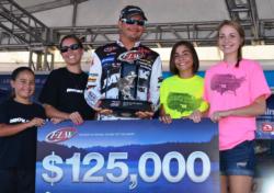 Jason Christie of Park Hill, Okla., shares the stage with his wife and daughters shortly after winning his second FLW Tour title of the season.