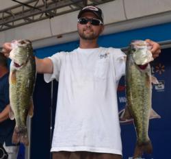 Second-place co-angler Shane Winchester holds up his two biggest bass from day one. 