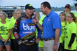 Surrounded by friends and family, Ray Scheide talks with FLW tourney host Chris Jones shortly before day-three takeoff.