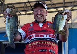 Third-place pro Matt Herren holds up his two biggest bass from day two on Lake Okeechobee.