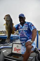 Ish Monroe holds up a big Lake Okeechobee largemouth.