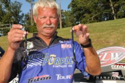 Albert Collins shows off his winning lures: a Mister Twister Hang 10 (left) and a Missile Baits Tomahawk worm (right)