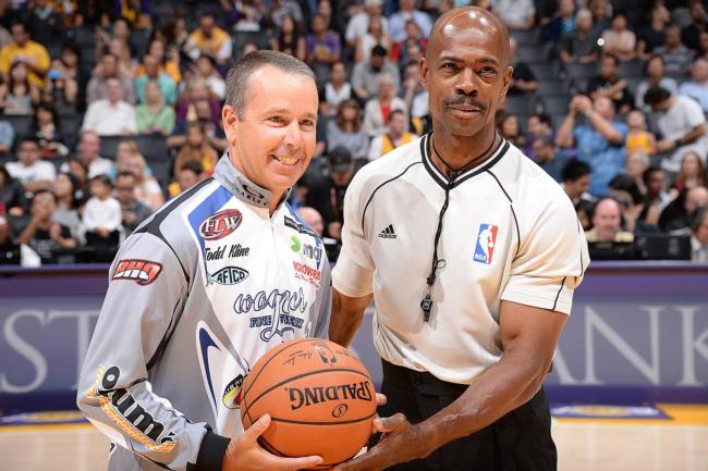 Todd Kline presents of the game ball at Sunday's Lakers game as he is honored for being the Rayovac Western Division Co-Angler Champion two years in a row. 