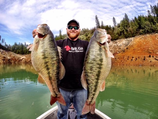 Jason Johnson hoists the two best fish of the trip. This photo also gives a good idea of the water clarity. 