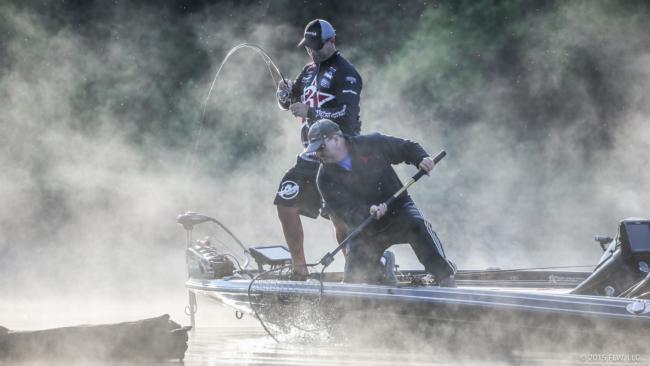 Brad Knight catching bass in the early morning fog. 
