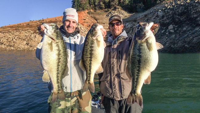 Paul Bailey (right) holds up the potential world record spotted bass weighing 11 pounds 4 ounces. Matt Newman (left) holds up a 6 and a 8 pound spotted bass. 