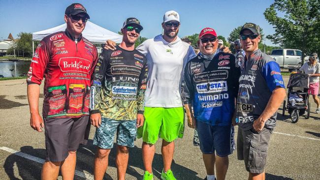 FLW Tour pros Matt Stefan, Jeff Gustafson, Andy Young and Austin Felix pose for a photo with MN Viking Brian Robison before heading out for the FLW Tour event in La Crosse.